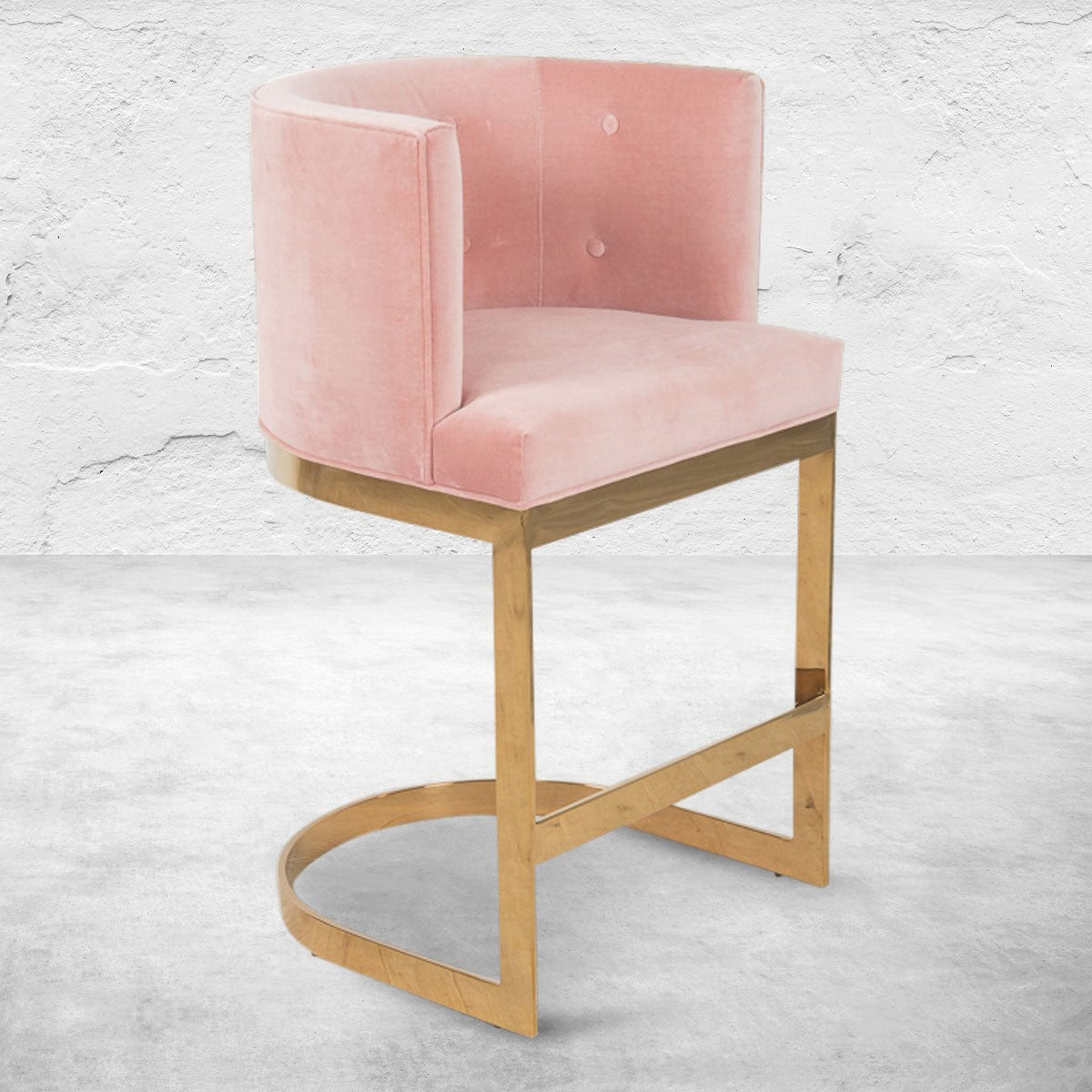 Art Deco style bar or counter stool with velvet blush upholstery, mid-rise back, button tufting and polished brass base.