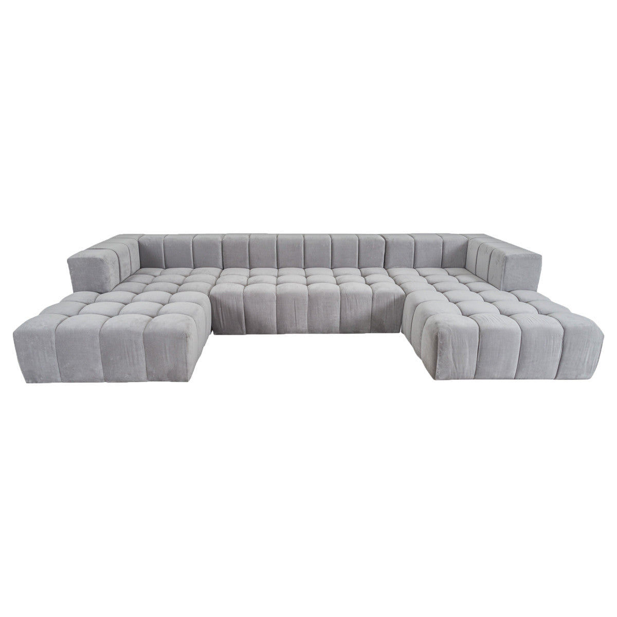 Modular light gray upholstered sectional sofa with double chaise lounges, a low back, straight sides, button tufted cushions and a channel tufted back.