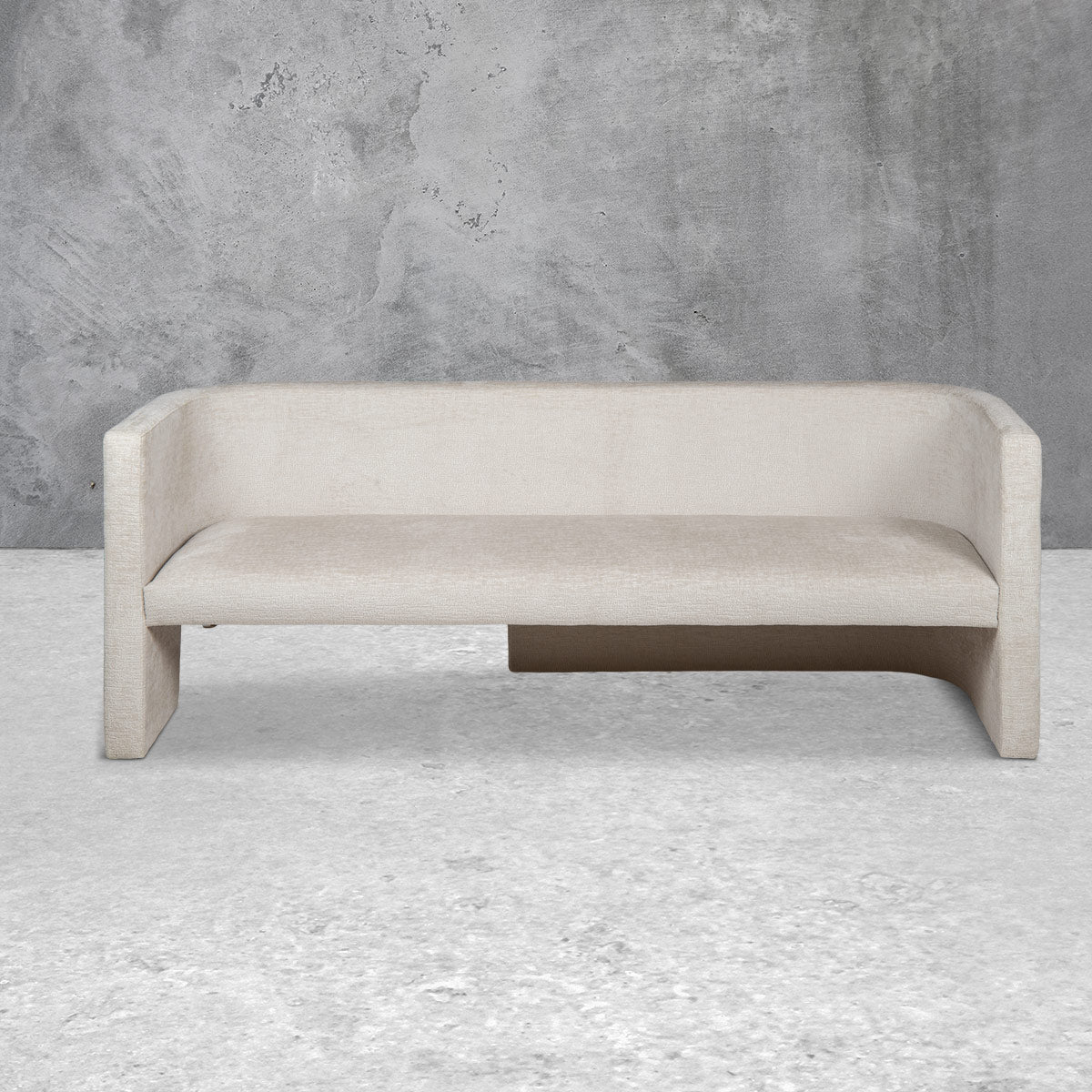 Bench style loveseat sofa with a mid-rise back, a single cushion, straight edges, a half-open base and light beige upholstery.