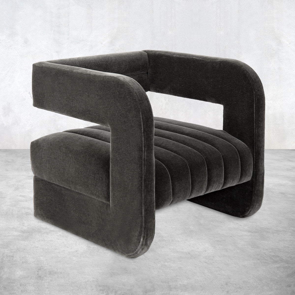 Ultra-modern occasional chair fully upholstered in black chenille with an open back and channel tufted cushion.